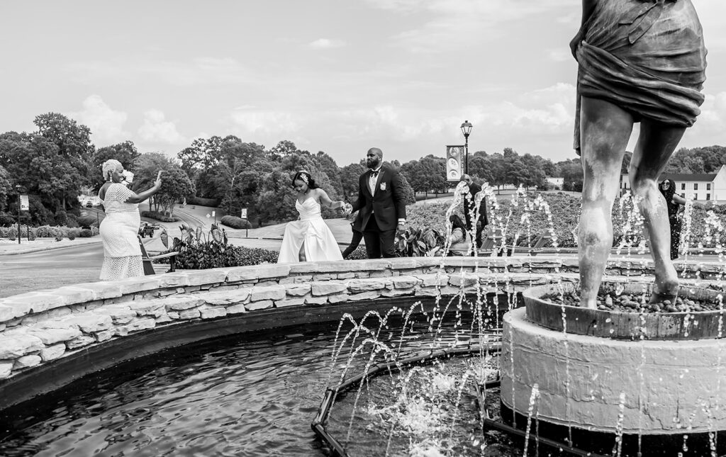 Elopement at Chateau Elan Winery captured by JAM&CO Studios Atlanta Elopement photographer Bride and groom walking around venue fountain