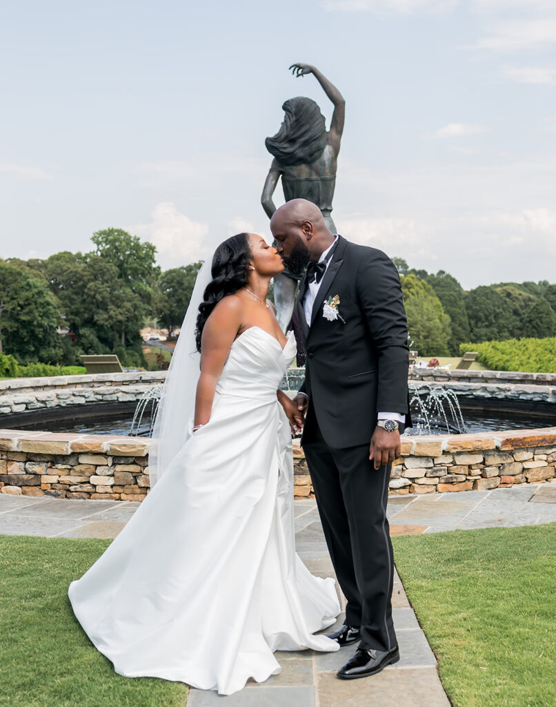 Elopement at Chateau Elan Winery captured by JAM&CO Studios Atlanta Elopement photographer Bride and groom kissing in front of fountain