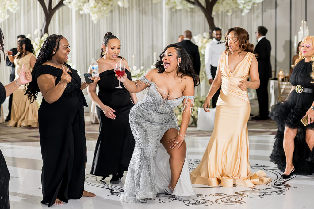 The Whitley Hotel Wedding captured by JAM&CO Studios wedding photo and video team bride dancing with friends during wedding reception
