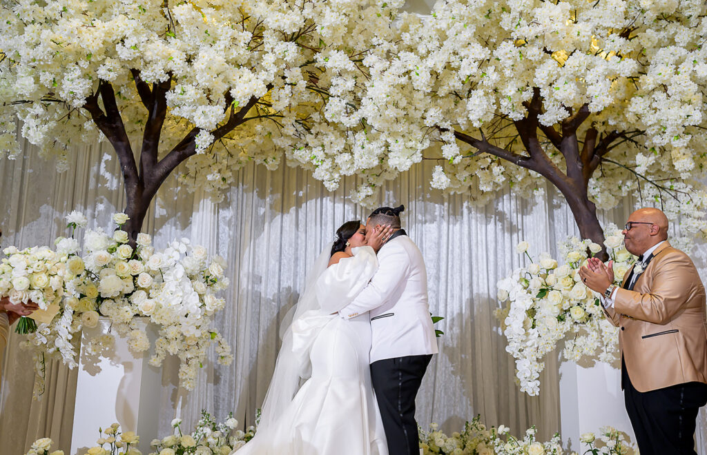 The Whitley Hotel Wedding captured by JAM&CO Studios wedding photo and video team couples first kiss at alter