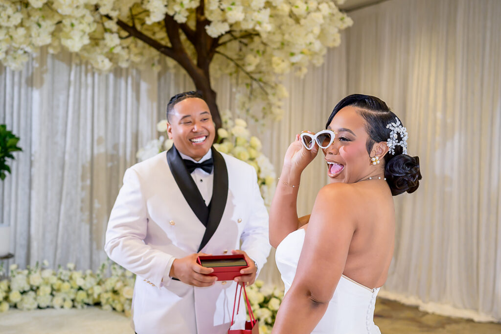 The Whitley Hotel Wedding captured by JAM&CO Studios wedding photo and video team bride trying on her gift from the groom